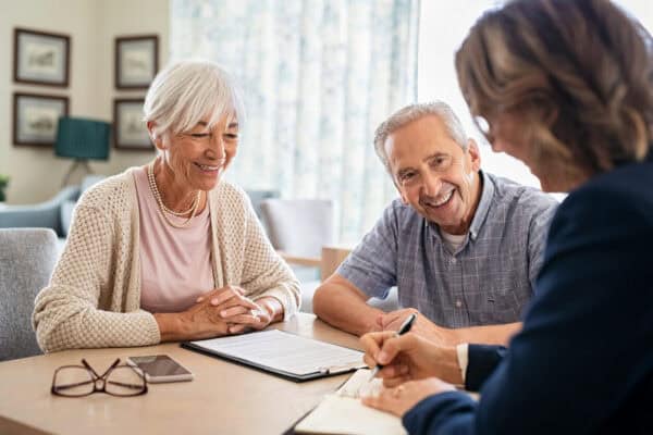 Couple sit with a professional to make funeral arrangements