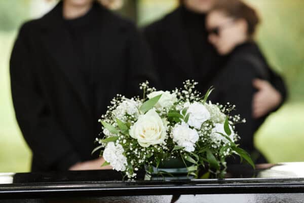 Family gathers to mourn at graveside - traditional funeral vs cremation