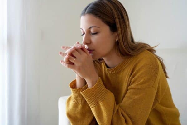 person prays during grieving process