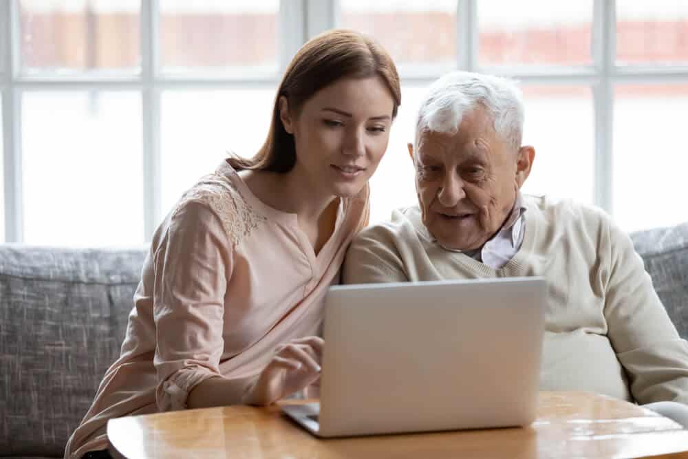 Younger woman helps older man answer the question, what is cremation insurance