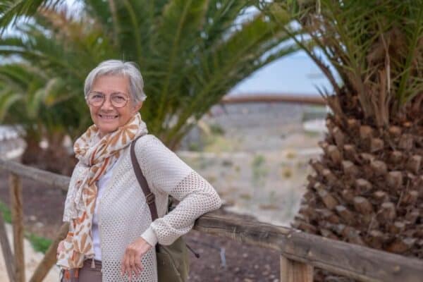 woman stands by palm trees - funeral services