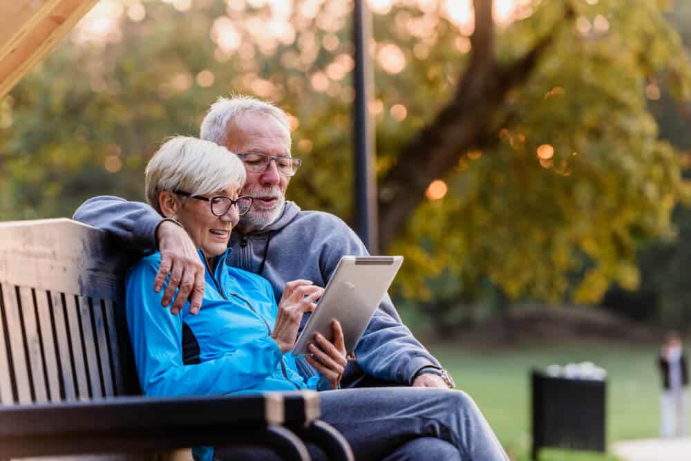 Couple uses tablet to create a cremation plan.